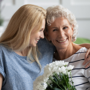 Woman hugging senior mother before vacation